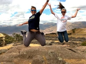 two girls jumping in the air in peru