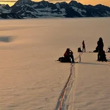 Students rest on a glacier 
