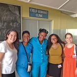 students posing for a picture with health care workers at a Child Guidance Clinic