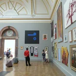 inside of an art museum with high ceilings
