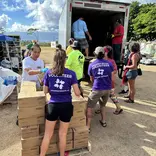 AHAH volunteers in purple shirts loading essential supplies for Hawaii wildfire relief