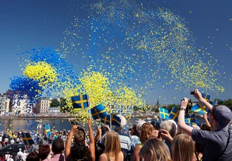 swedish festival with balloons in the air and people celebrating