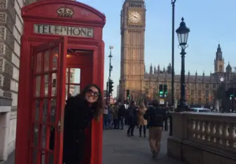 Intern in phonebooth in front of Big Ben 