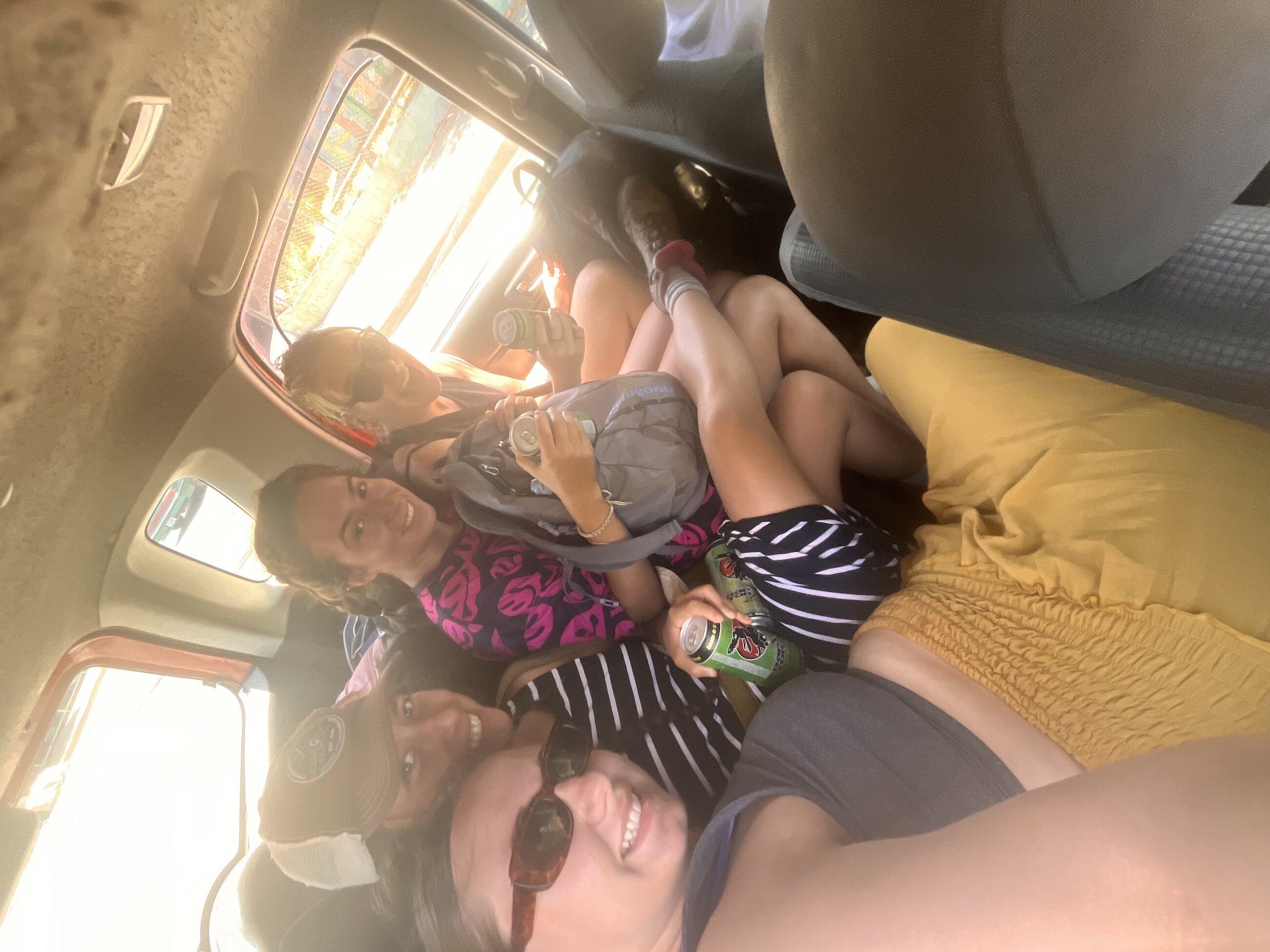 My friends and I cramming 4 people into a 3-person backseat of a taxi in Puntarenas