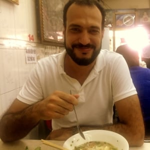guy eating soup and smiling