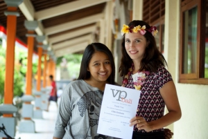 two women in bali holding a school certificate