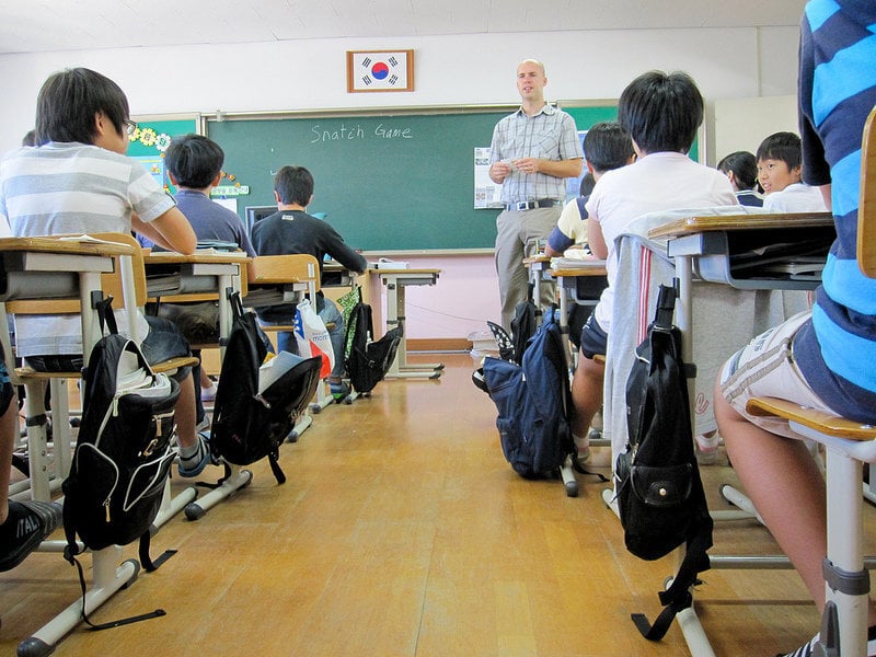 Greenheart A teacher stands at the front of the classroom in South Korea.