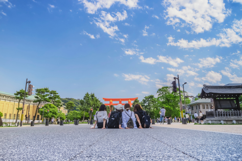 Four students sitting on the ground