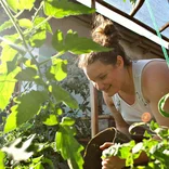 Adding soil to a raised garden bed