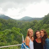 Study abroad students in the Costa Rican rainforest with a waterfall