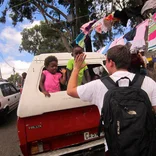 student high-fiving two local kids