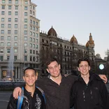 three students standing in front of building on a street in Barcelona