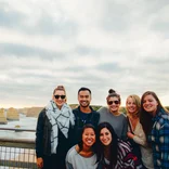 group of students standing at a lookout point that looks out over the coastline and cliffs