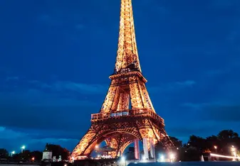 The Eiffel Tower lit up at night 