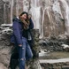 jane balancing herself in front of a waterfall in plitvice lakes, croatia