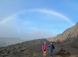 Rainbow over student and Overseas Educator