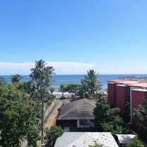 sunny blue skies, overlooking a beach